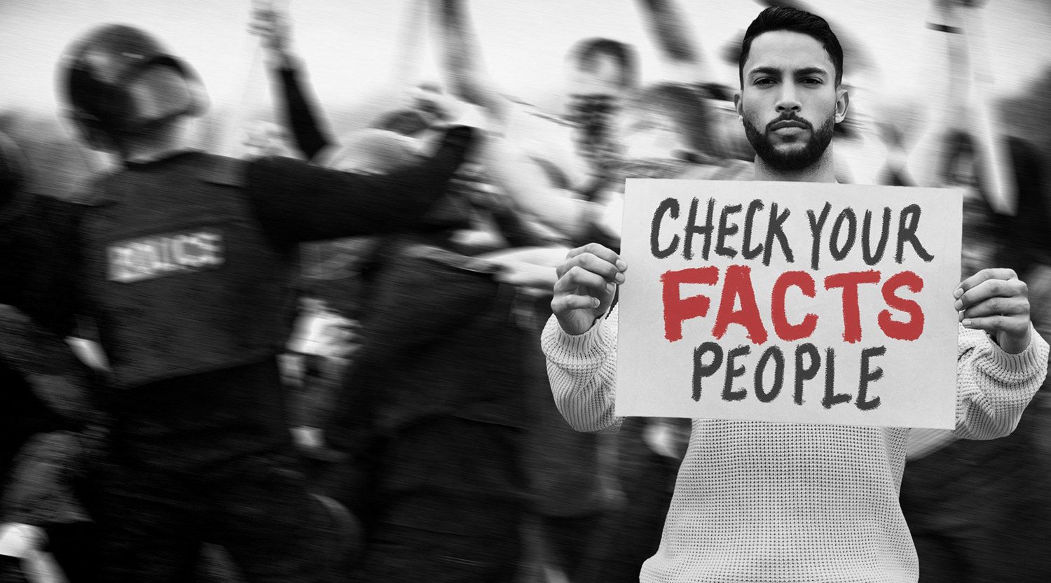 person holding a sign at a rally that says 'check your facts people'