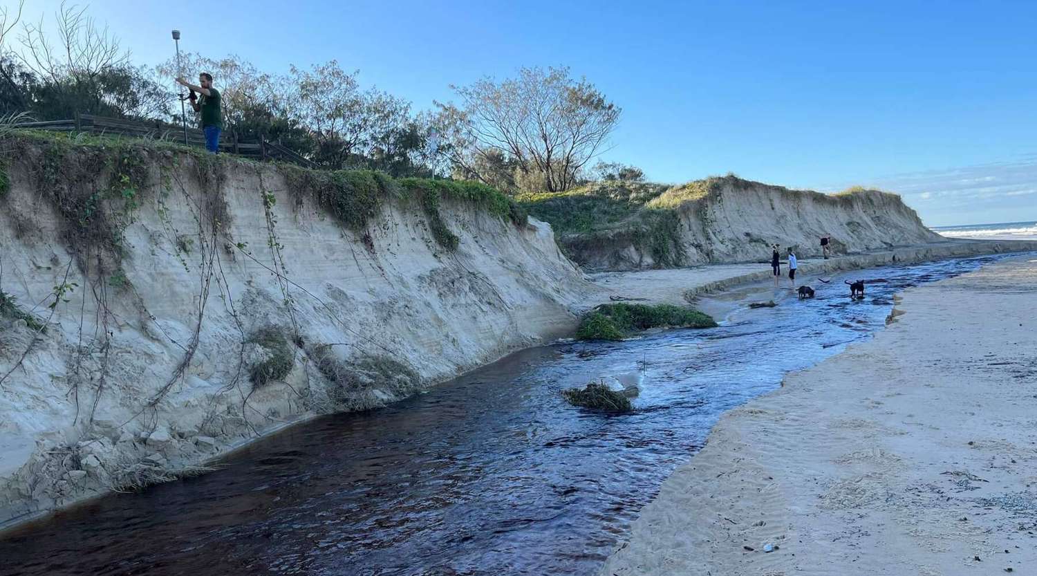 Dr Javier Leon measures beach erosion at Burgess Creek, Noosa caused by waves and extreme rainfall in early 2022. 