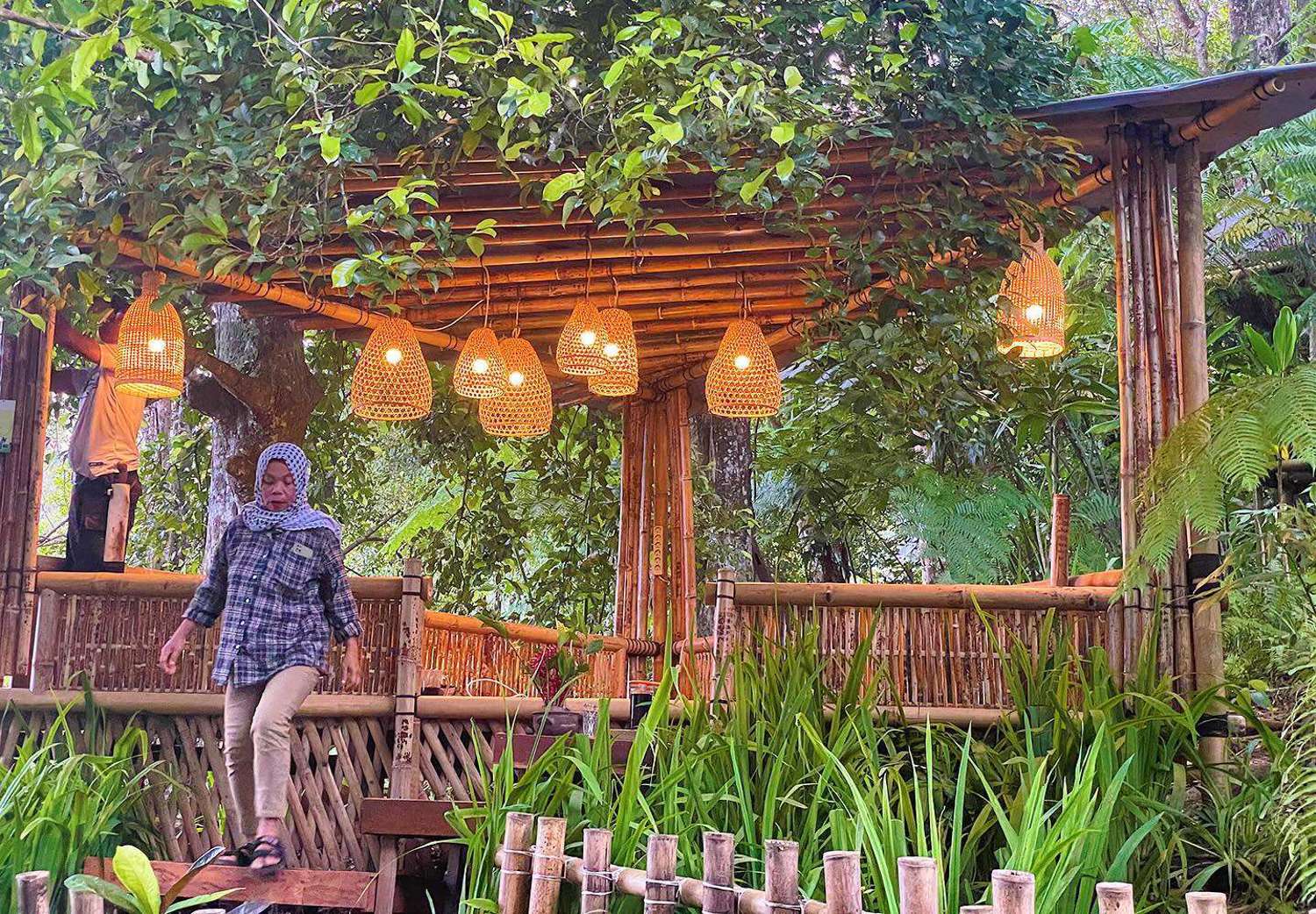 women walking from bamboo balcony of spice village restaurant