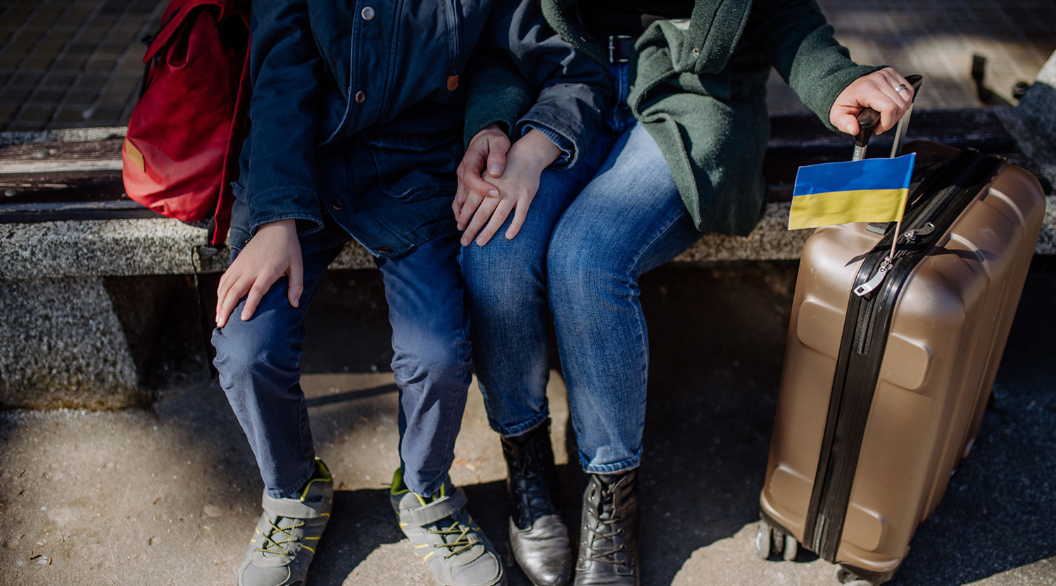 Refugee family sitting in station 